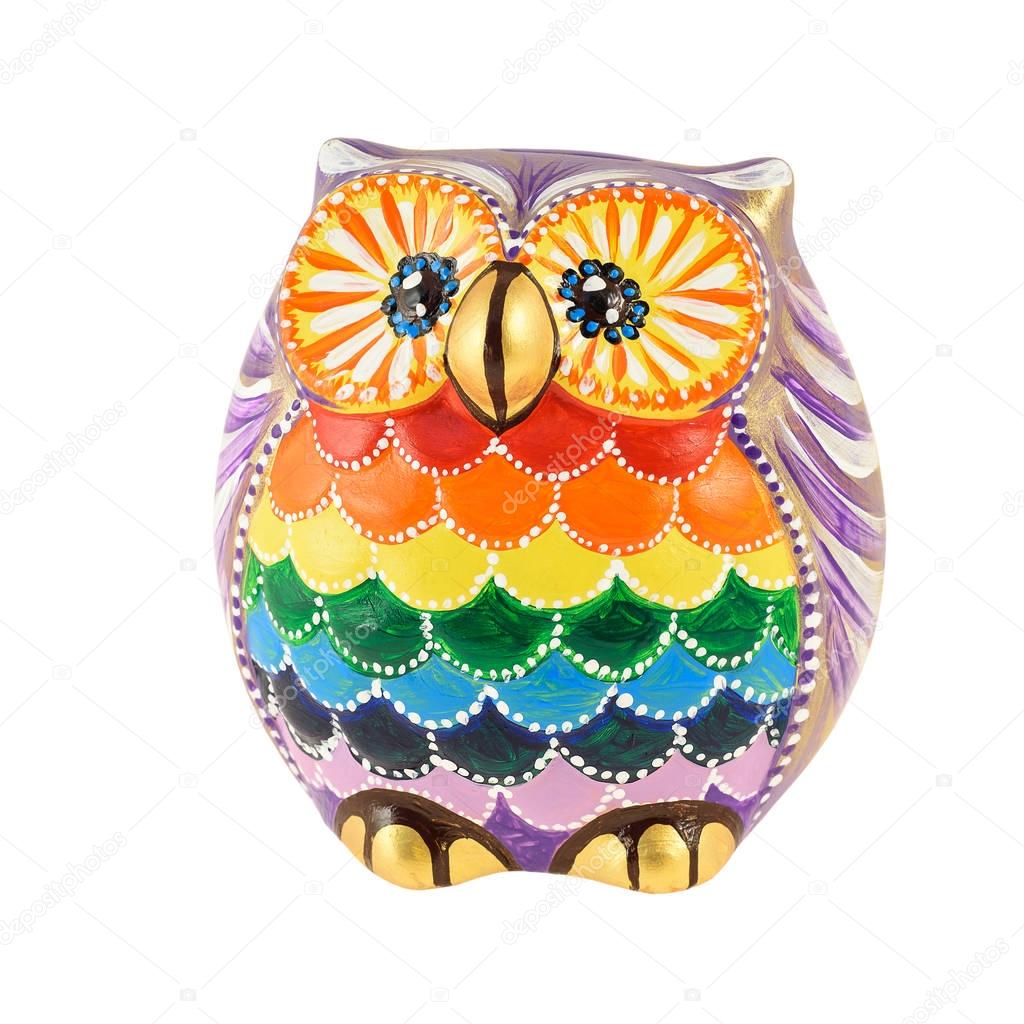 A clay figurine of an owl painted in bright colors
