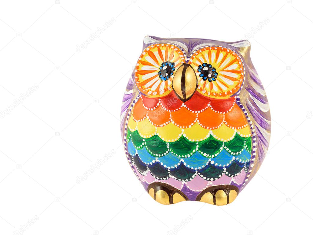 A clay figurine of an owl painted in bright colors