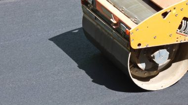 road roller makes the paving clipart