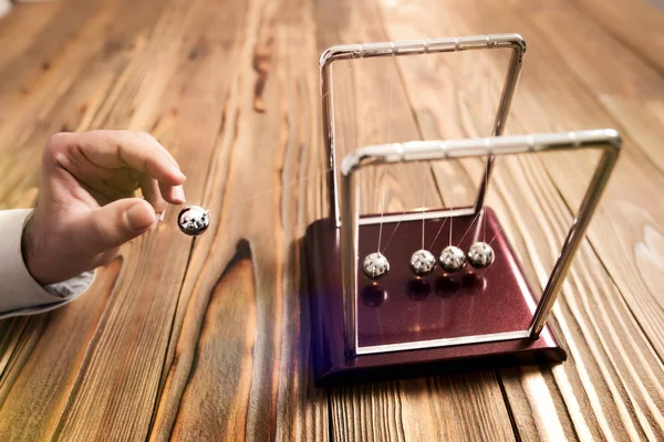 Concept For Action and Reaction in Business With Newton's Cradle