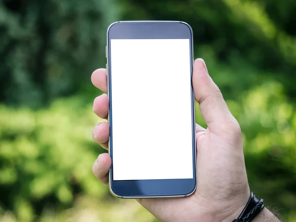 Mano del hombre sosteniendo teléfono inteligente móvil con pantalla blanca en blanco —  Fotos de Stock