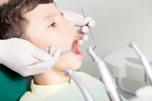 Dentist examining kid\'s teeth