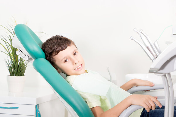 Little kid smiling at dental clinic