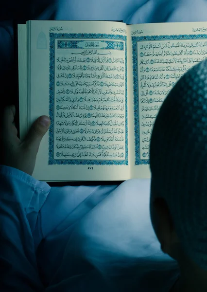 Criança muçulmana lendo o Alcorão na noite do Ramadã — Fotografia de Stock