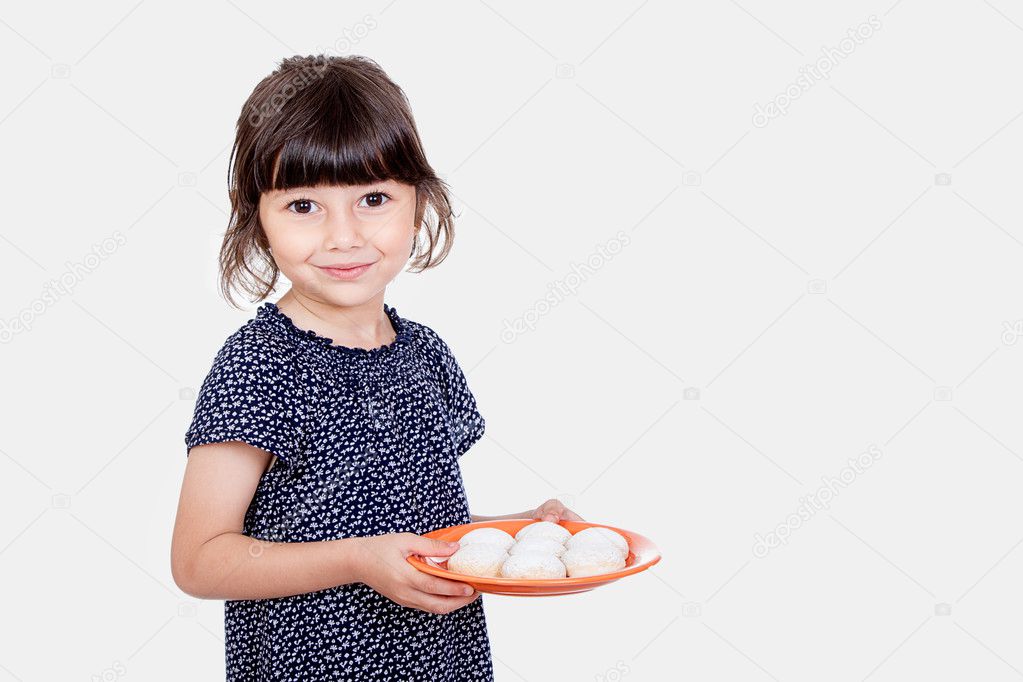 Muslim girl presenting kahk ( cookies ) in the feast