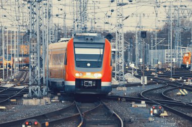 Modern orange commuter train on a railroad