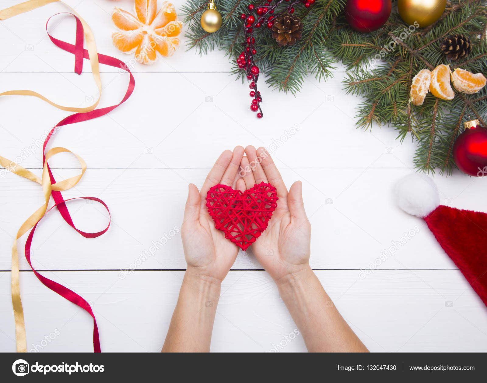 Hands Holding Red Wicker Heart On Christmas Decorations Backgrou