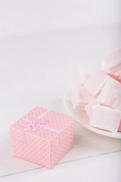 Soft pink and white marshmallow with gift box on white backgroun