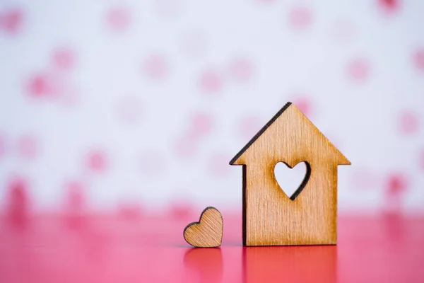 Casa in legno con foro in forma di cuore con poco cuore sulla spilla — Foto Stock