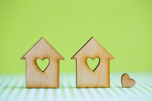 Two wooden houses with hole in form of heart with little heart o — Stock Photo, Image