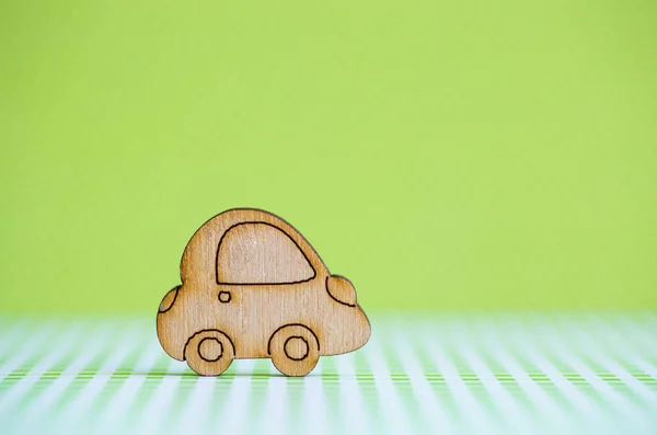 Wooden car icon on light green background