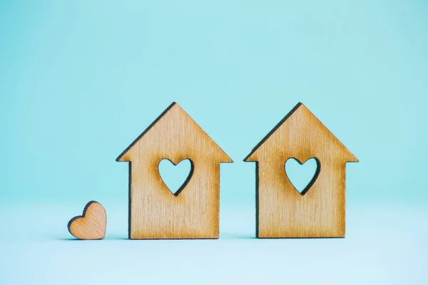 Two wooden houses with hole in form of heart with little heart o — Stock Photo, Image