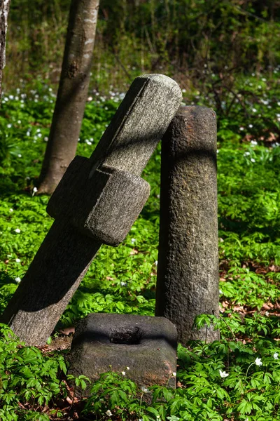 Old stone cross in forest