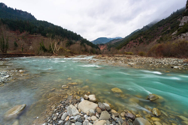 Mountain river in cloudy day