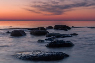 Gün batımında taştan deniz kıyısı