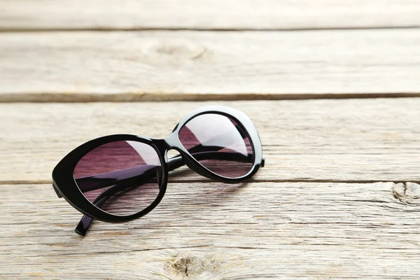 Black sunglasses on table — Stock Photo, Image