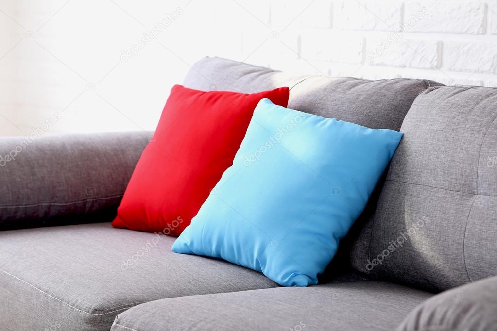 Colorful pillows on grey sofa 