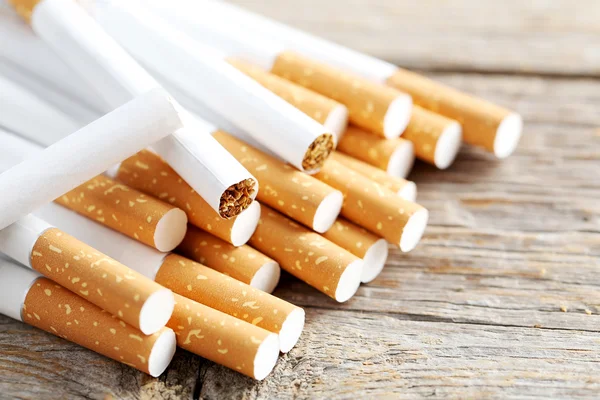 Tobacco cigarettes on table Royalty Free Stock Photos
