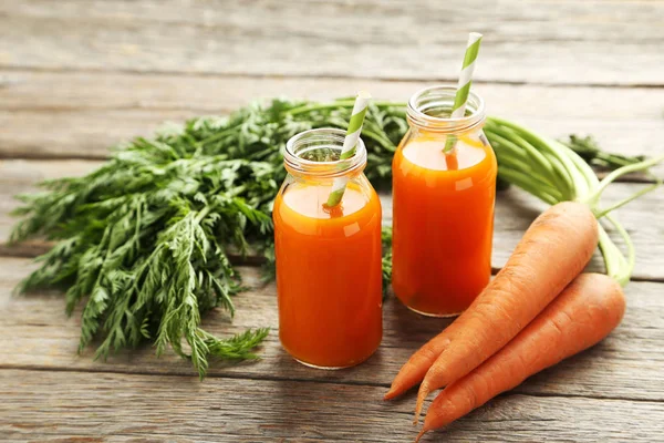 Fresh carrot juice in bottles — Stock Photo, Image