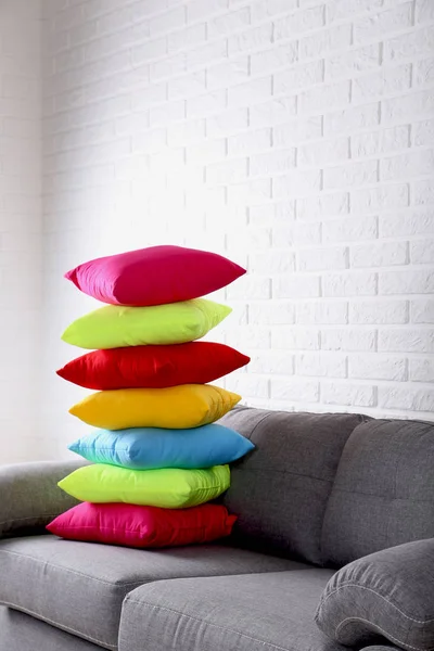 Colorful pillows on grey sofa — Stock Photo, Image