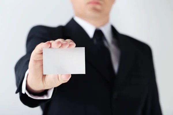 Businessman holding blank card — Stock Photo, Image