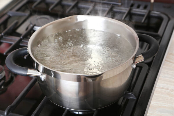 Water boiling into saucepan 