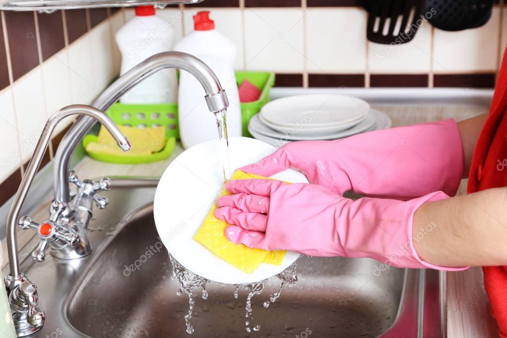 hands washing dish