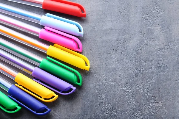 Colored pens on grey table — Stock Photo, Image