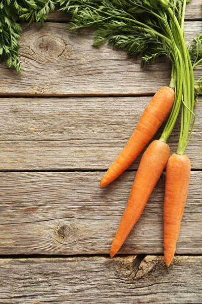 Carrot on wooden table — Stock Photo, Image