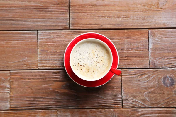 Cup of coffee on wooden table — Stock Photo, Image