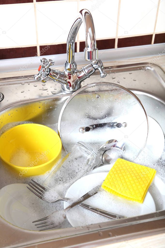 kitchenware with sponge in sink