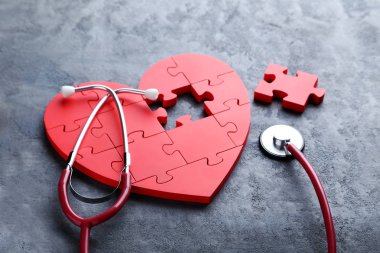 Red puzzle heart with stethoscope  clipart