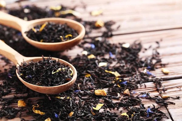 Dry tea on brown wooden table — Stock Photo, Image