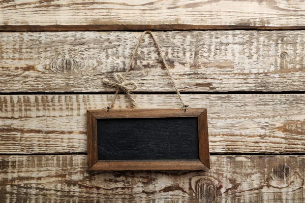 Frame hanging on wooden wall — Stock Photo, Image