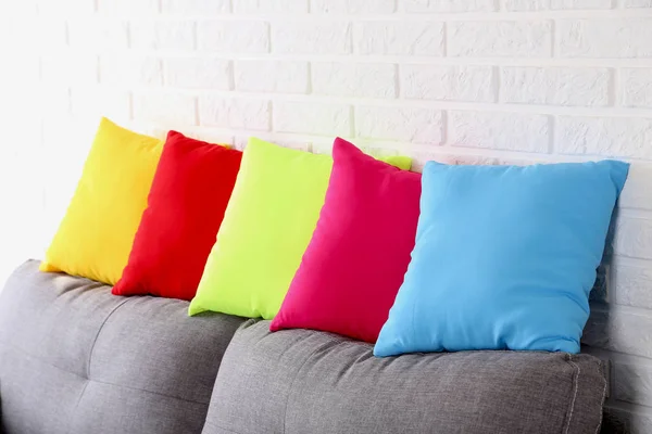 Colorful pillows on grey sofa — Stock Photo, Image