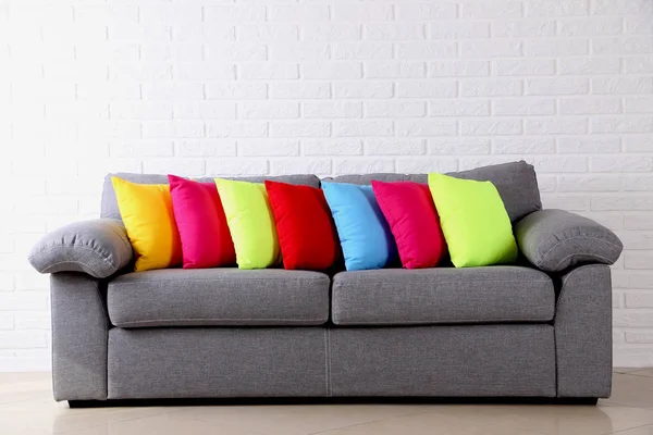 Colorful pillows on grey sofa — Stock Photo, Image