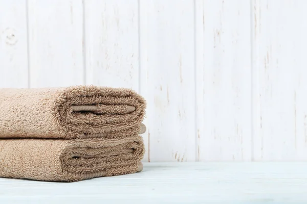 Beige towels on white table — Stock Photo, Image