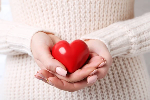 Woman with heart in hands — Stock Photo, Image