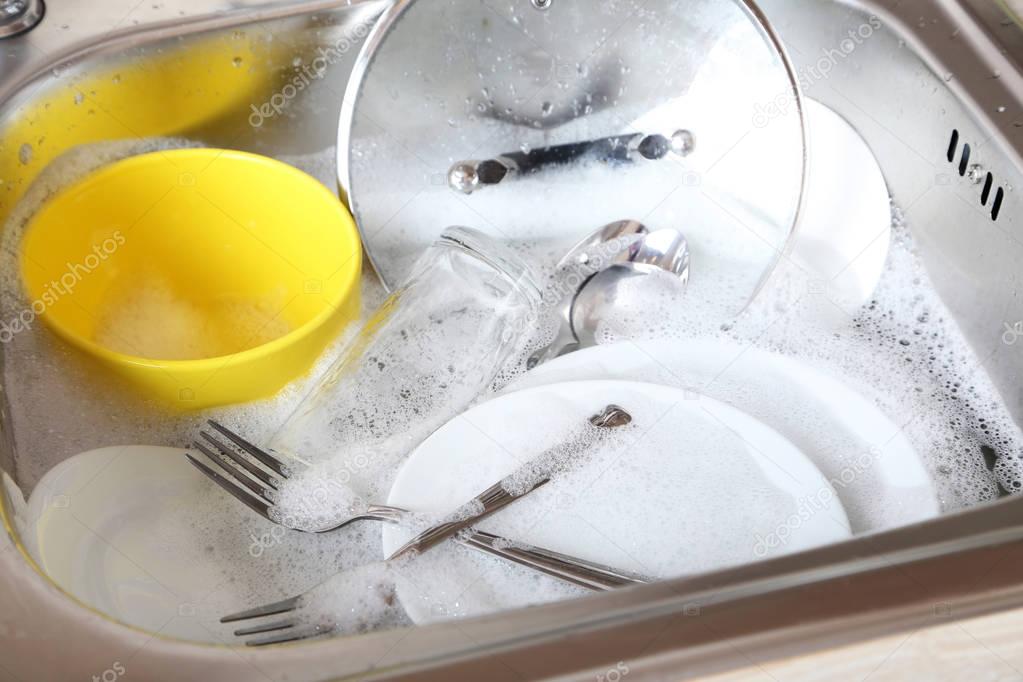 Dishes soaking in sink 