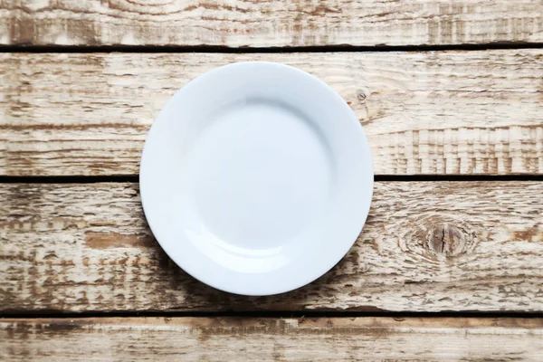 Plate on wooden table — Stock Photo, Image