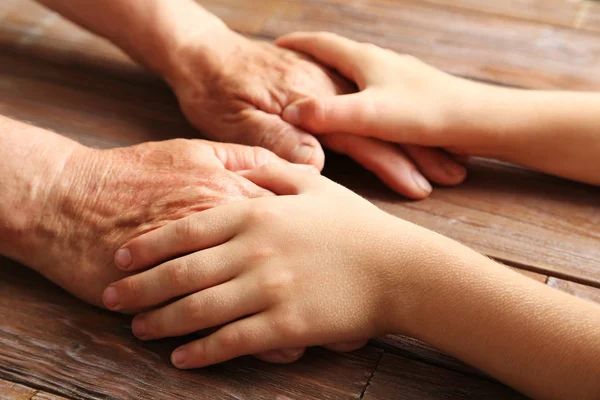 Hands of child and senior — Stock Photo, Image