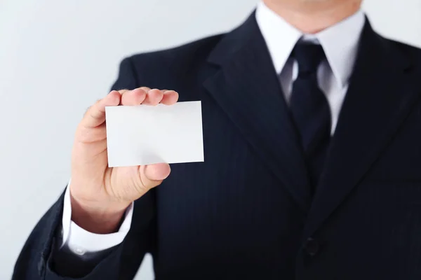 Businessman holding card — Stock Photo, Image