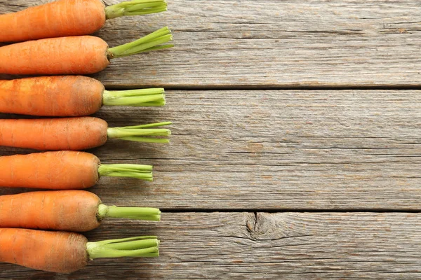 Carrots on wooden table — Stock Photo, Image