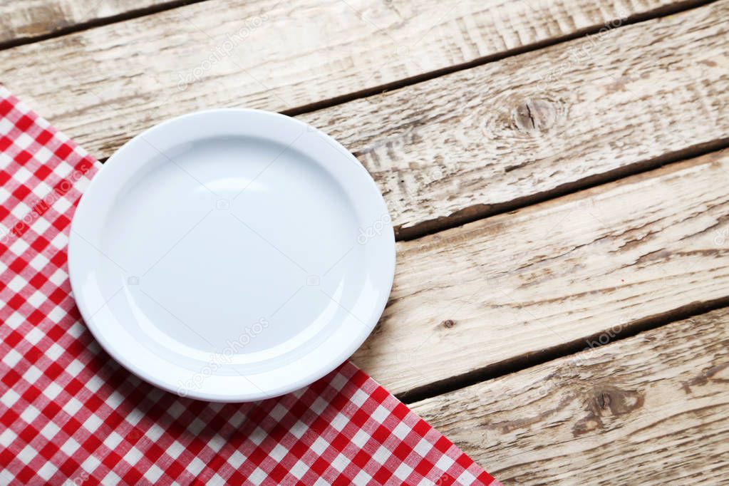 Empty white plate with napkin