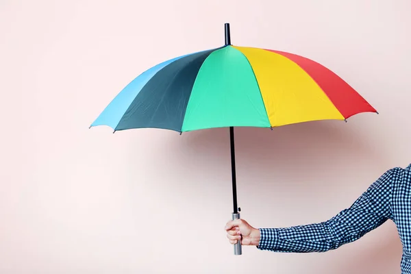Colorful umbrella in man hand — Stock Photo, Image
