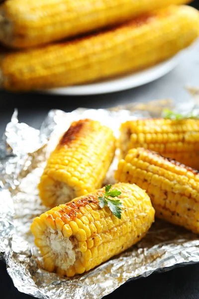 Grilled corn on table