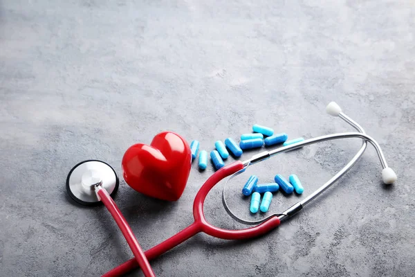 Stethoscope with pills and red heart — Stock Photo, Image