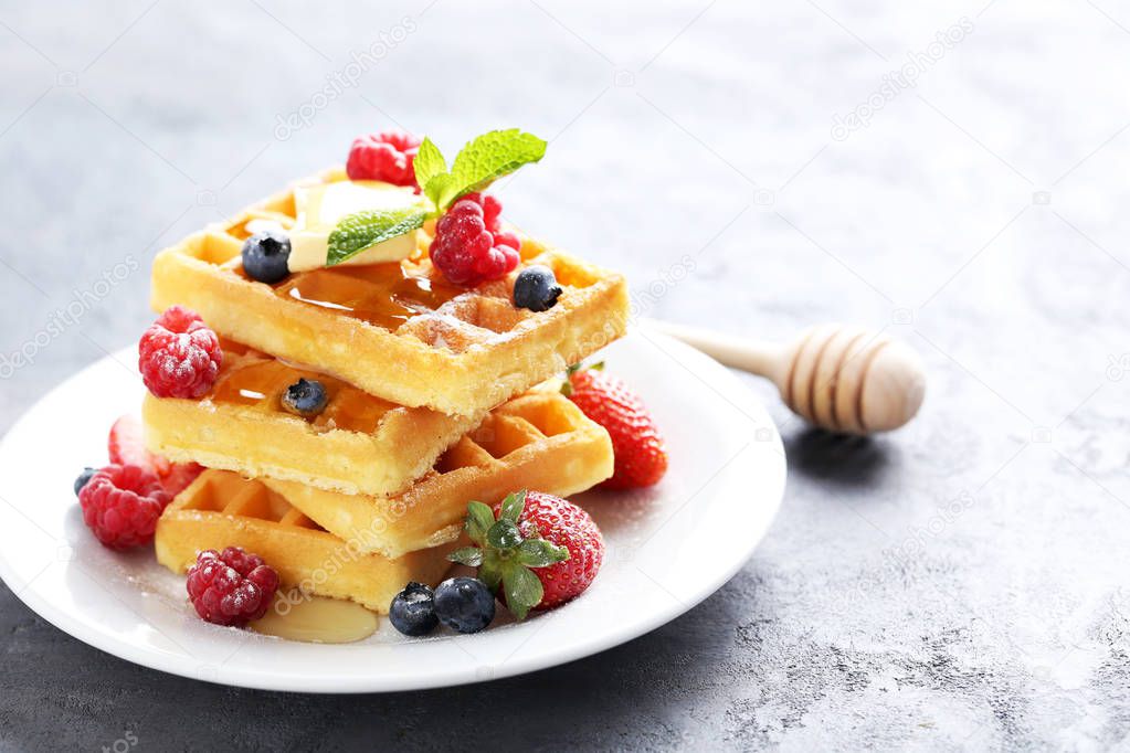 Homemade waffles with berries in plate 