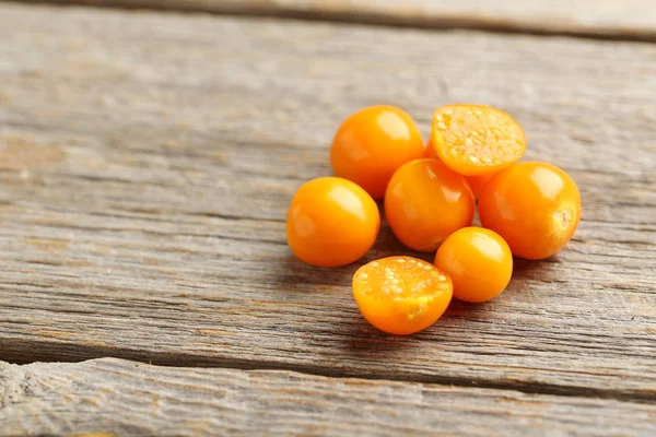 Ripe physalis on a grey wooden table — Stock Photo, Image