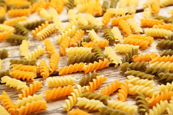 Spiral pasta on the brown wooden table — Stock Photo, Image